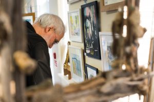 Visitor looking at art at the pop up art weekend