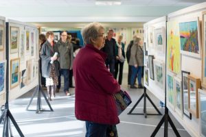 Woman admiring art at the pop up art weekend