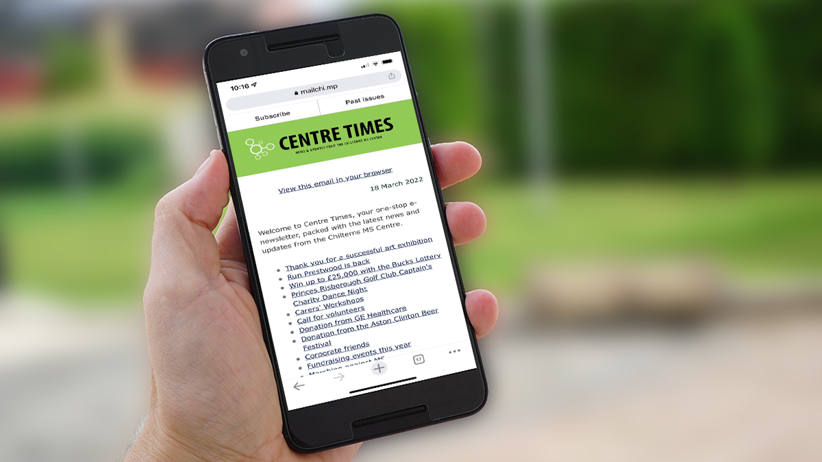 Hand holding up a smartphone displaying the Chilterns MS Centre supporter newsletter