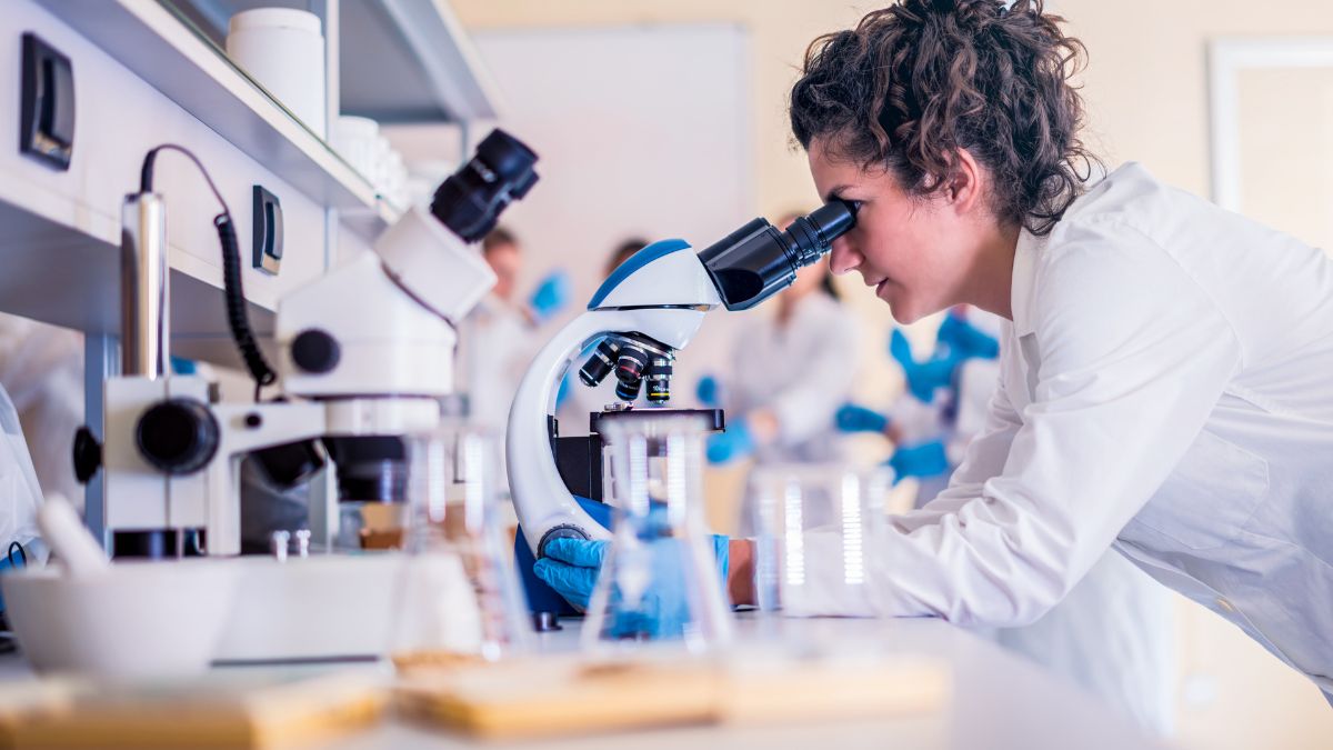 Scientist looking into a microscope in a laboratory